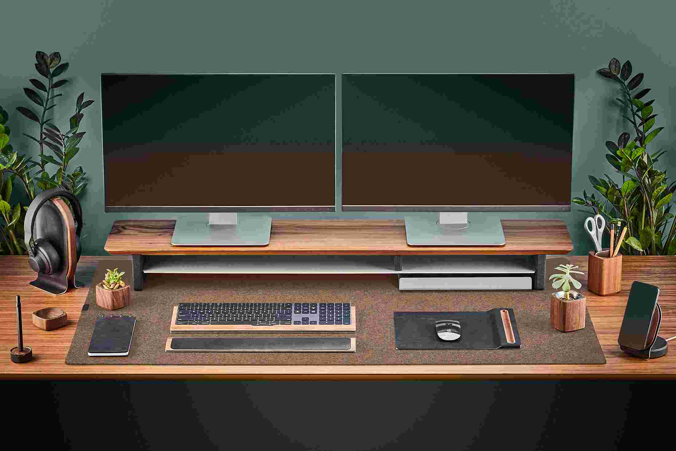 The Extra Large Wool Felt Desk Pad in Light Brown covering almost an entire desktop, in use with the Walnut Desk Shelf System.