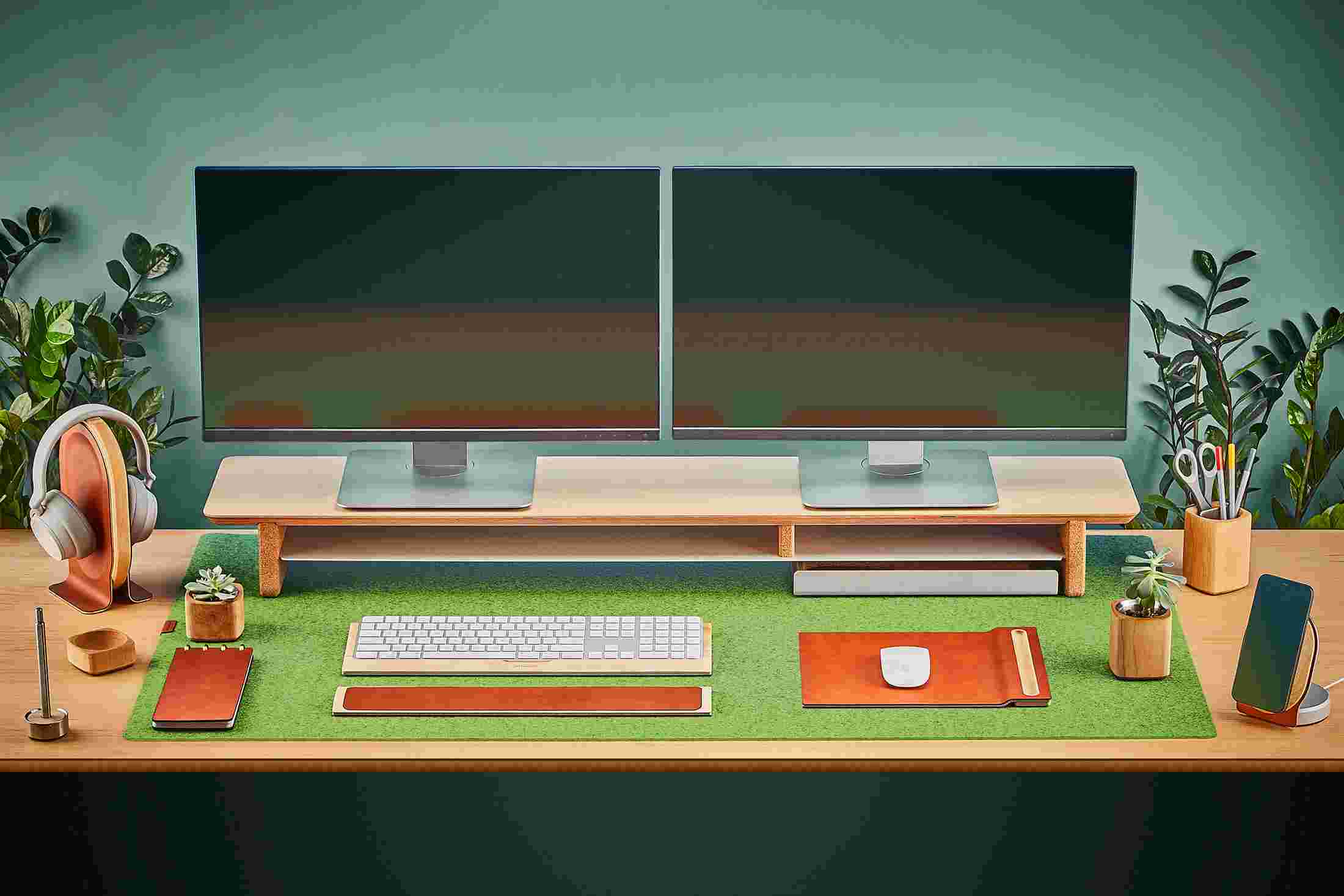 The Extra Large Wool Felt Desk Pad in Light Green covering almost an entire desktop, in use with the Maple Desk Shelf System.