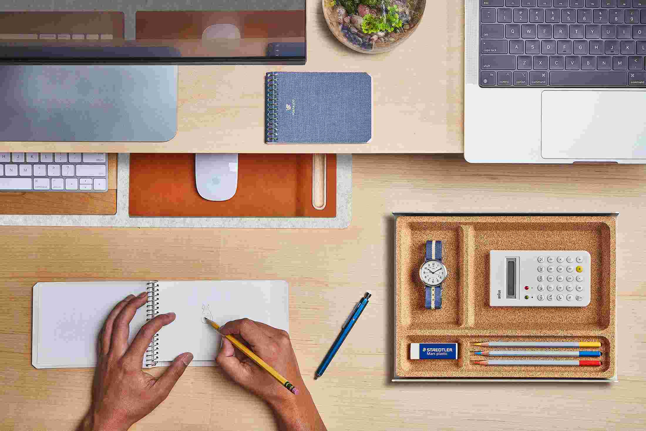 The Small White Wool Felt Desk Pad tucked under the Maple Desk Shelf, creating space to sketch and write.
