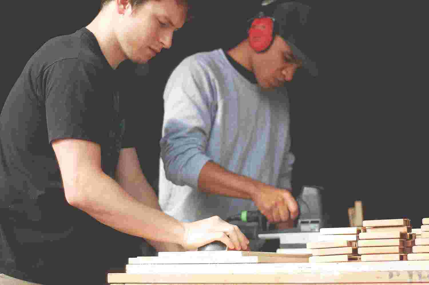 workers sanding iphone cases