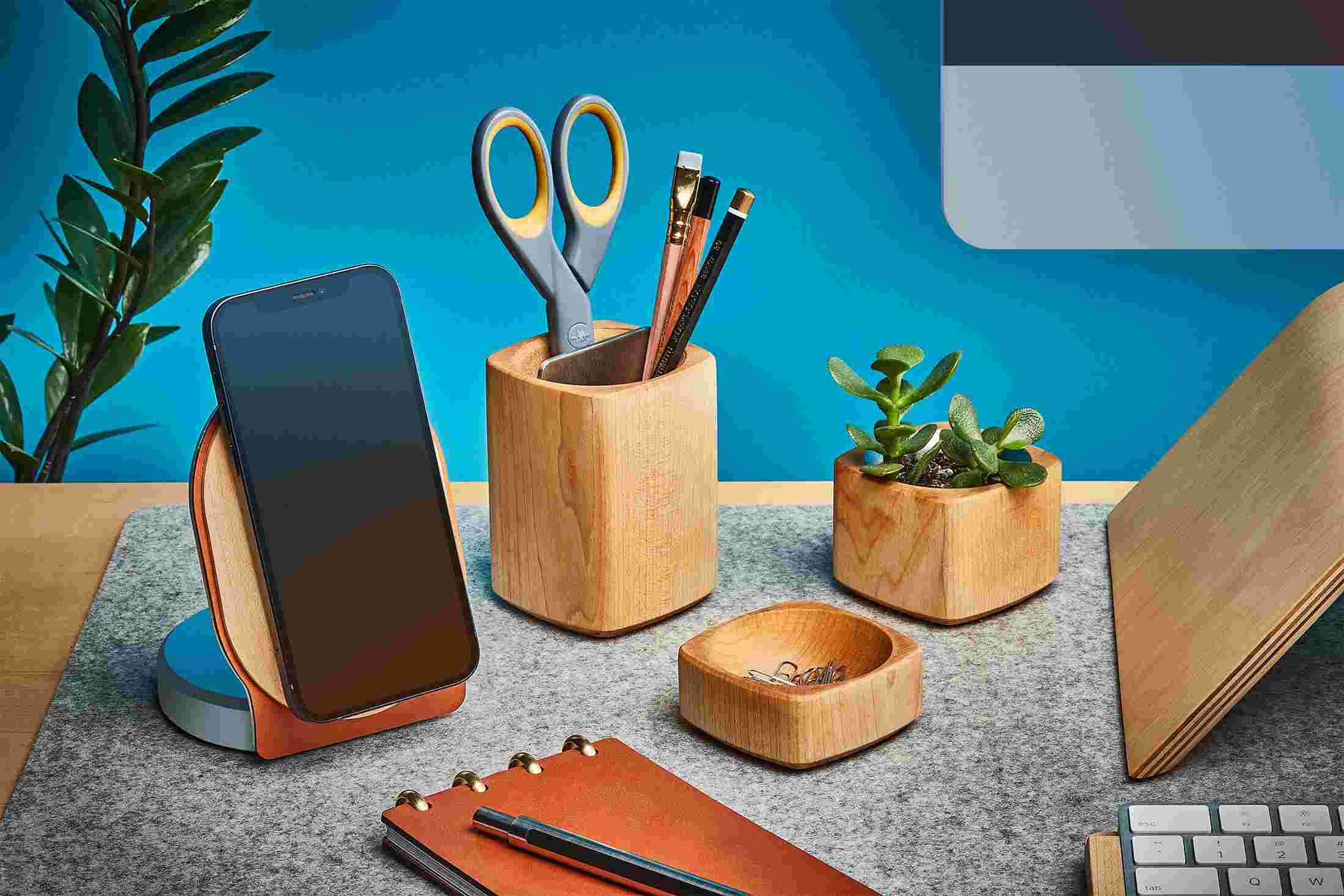 Maple wood iPhone 12 MagSafe Holder on wool felt desk pad with matching desk accessories.