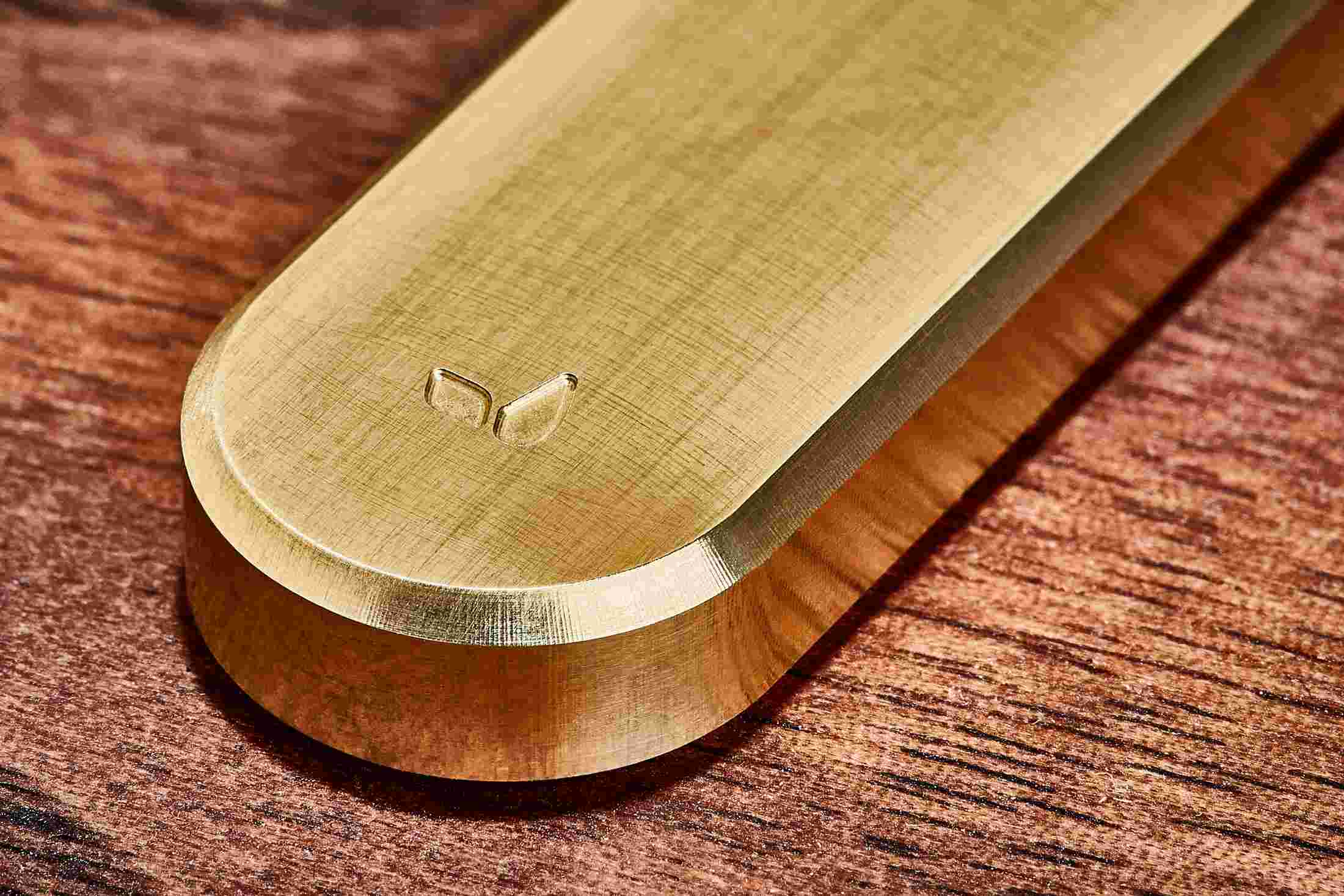 Detail of the fine machining marks on the brass task knife.